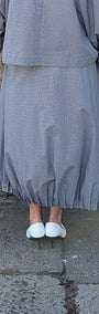 light blue grey striped maxi shirt dress with a white undershirt and white pointed-toe heels.