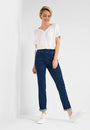 Front view  short leeve top and blue jeans with a high waist and slim fit. 