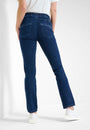 Back view  a pink long sleeve top and blue jeans with a high waist and slim fit. 