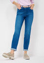 Front view  a pink long sleeve top and blue jeans with a high waist and slim fit. 
