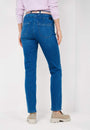 Back view  a pink long sleeve top and blue jeans with a high waist and slim fit. 