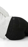 Person wearing black pants with a visible brand logo on a white background