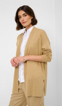 A woman wearing a sand knit cardigan with a fwhite shirt   Front view.