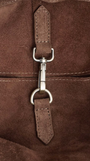 Close-up of a brown leather bag with metal zipper pull