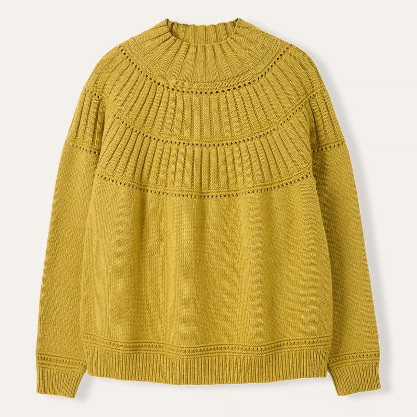 Mustard yellow sweater on a light beige background