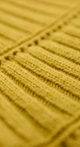 Close-up of a textured yellow fabric with a ribbed pattern