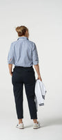 Person wearing a blue and white striped shirt with black pants on a white background