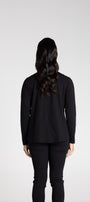 Person wearing a black long-sleeve top and pants on a white background