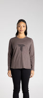 Person wearing a brown long-sleeve shirt with a logo on a white background
