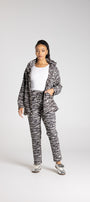 Person wearing a zebra print tracksuit on a white background