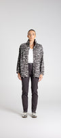 Person wearing a zebra print jacket on a white background