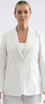  white pinstriped blazer over a white top, shown from the waist up .