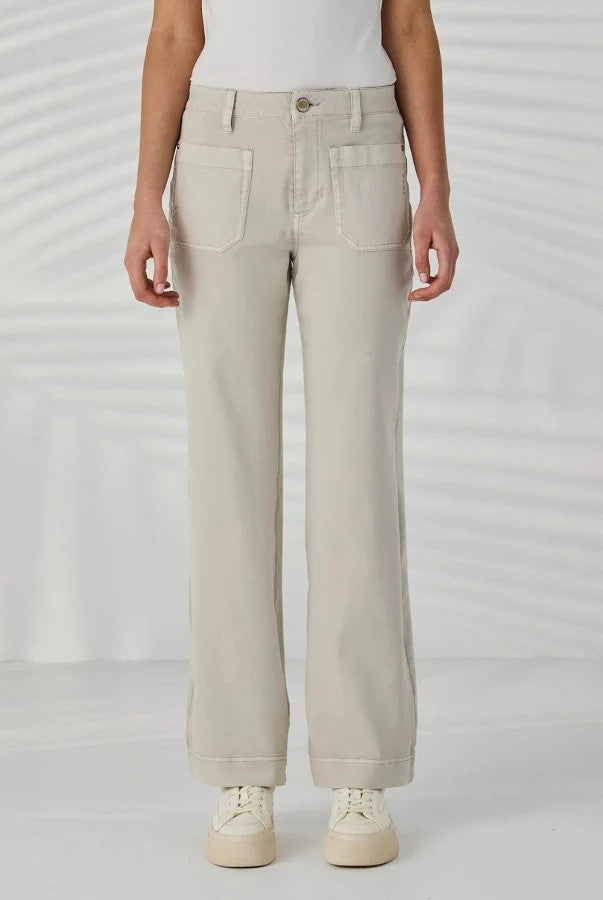 light beige wide leg jeans with a white top and white sneakers.