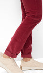 Red pants worn with beige sneakers 
