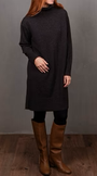 Person wearing a long black sweater and brown boots.
