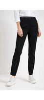 Front view black pants and white shoes.
