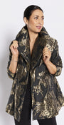 Woman wearing a black and gold floral patterned jacket on a white background
