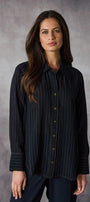 Woman wearing a dark pinstripe shirt against a gray background