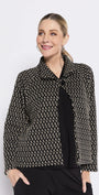 Woman wearing a black and white patterned jacket on a white background