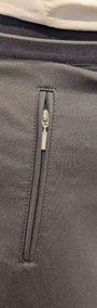 Close up of black pants with a zipper detail.