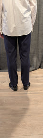 Back view white shirt and navy pants.