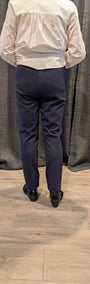 Back view white shirt and navy pants.