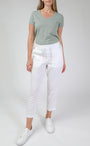 whit linen pants and a sage t-shirt.